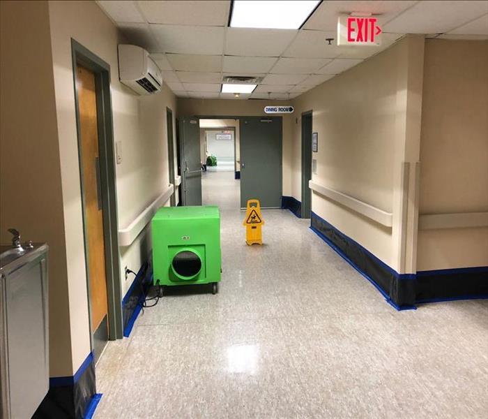 Clean hallways after a healthcare restoration project with a Hepa Air Scrubber for a last deep cleaning